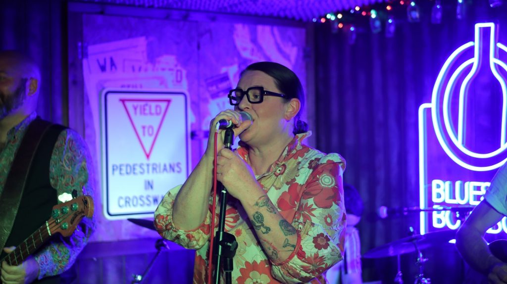 Woman standing in front of microphone singing