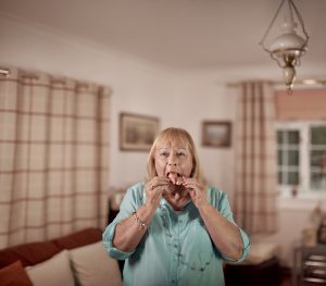 A woman removing her obturator from her mouth