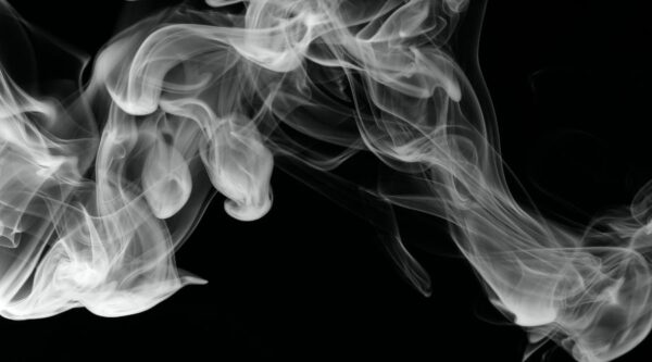 Image of white smoke drifting across black background